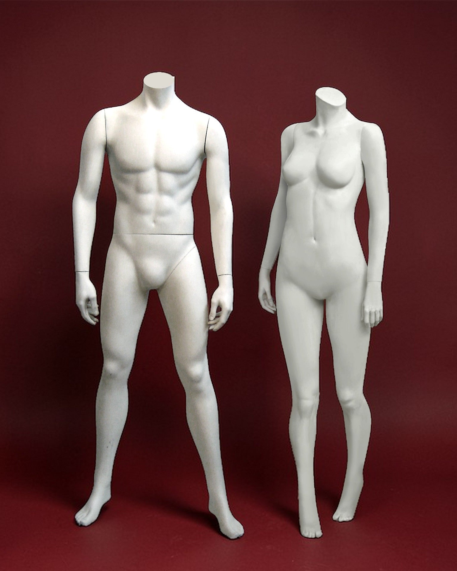 White male and female mannequins on a red background